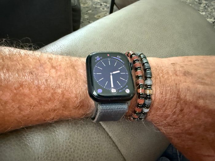 Man wearing the Wayfinder beaded bracelets with genuine gemstone beads and versatile everyday style.