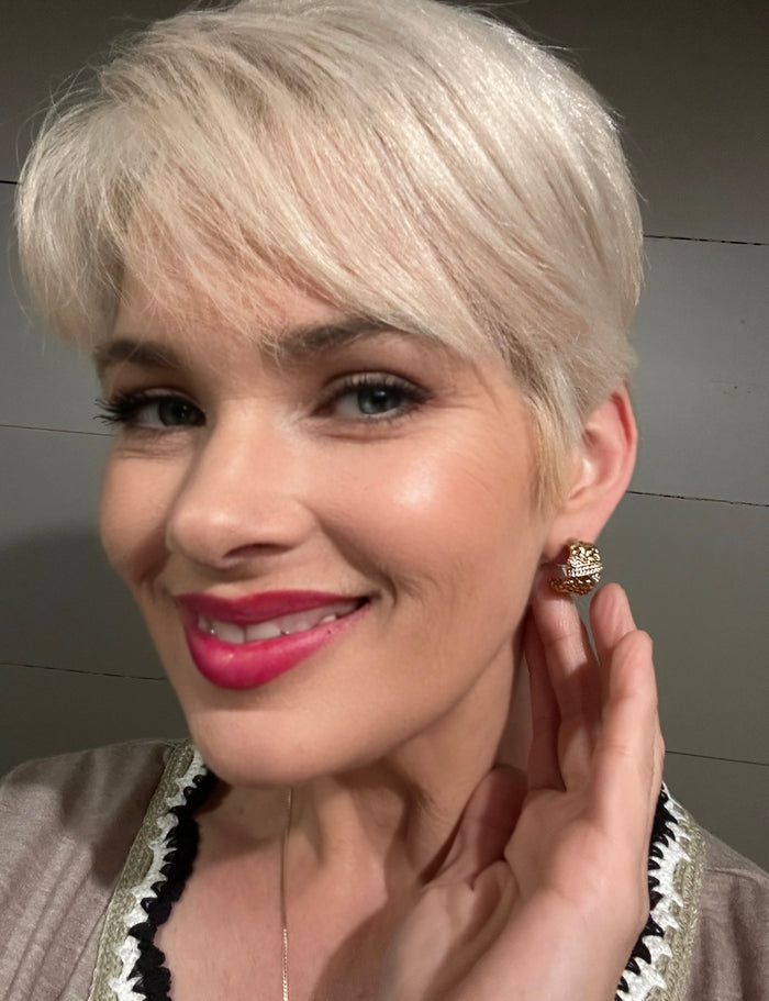 Close-up of model wearing VEITA Jewelry gold textured dome stud earring with delicate chain necklace