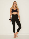 Model wearing black mid calf length, 3/4 tights, double layered high waistband, women's bamboo clothing