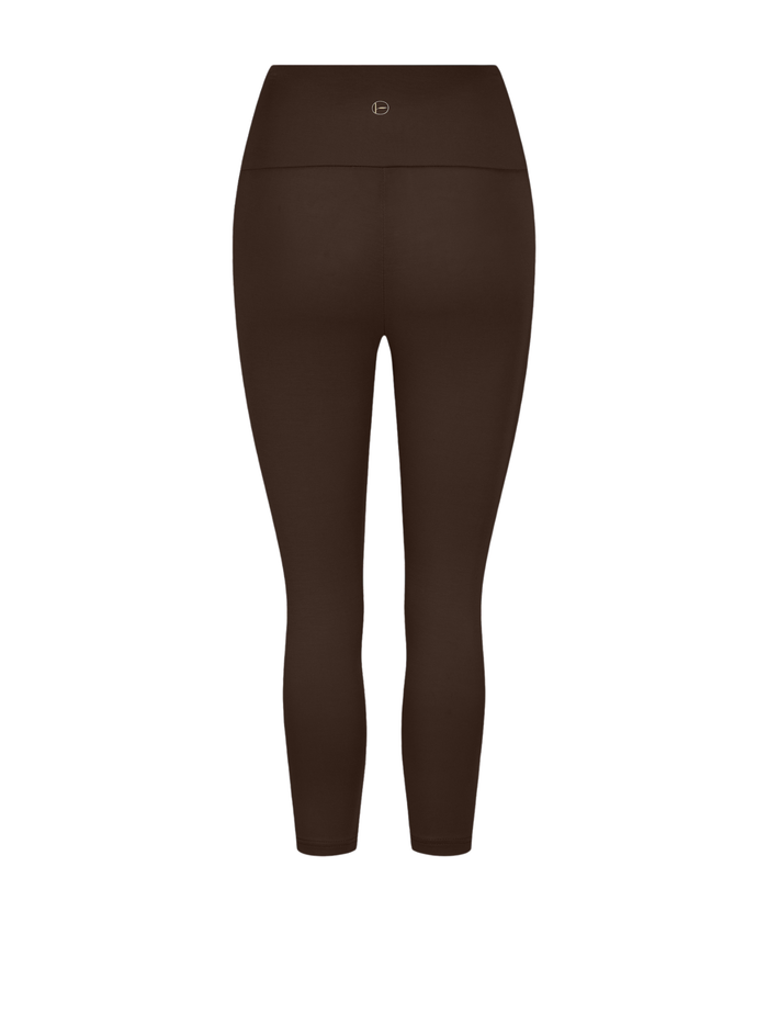 A pair of high-waisted, 3/4  length leggings in a dark brown shown on a plain white background.