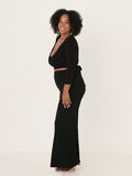 Model wearing a black ballet wrap cardigan with plunge neckline and fitted 3/4 sleeves and tie detail, women's bamboo clothing