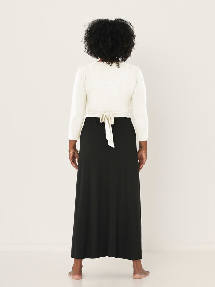 Model wearing a cream ballet wrap cardigan with plunge neckline and fitted 3/4 sleeves, women's bamboo clothing