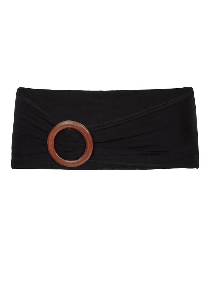 Model wearing black bamboo fabric belt with round natural brown wooden buckle, women's bamboo clothing accessories