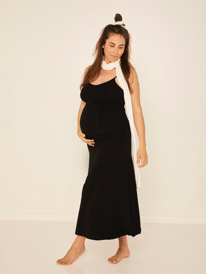 Model wearing black body singlet with in-built bralette, subtle v front and adjustable straps, women's bamboo clothing