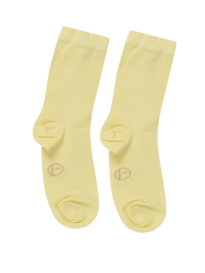 Pair of light yellow bamboo socks on a white background