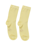 Pair of light yellow bamboo socks on a white background
