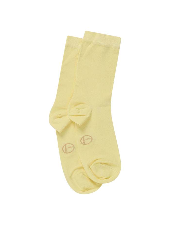 Pair of light yellow bamboo socks with a bow on a white background