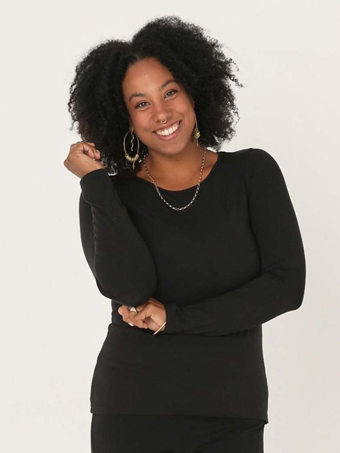 Model wearing a reversible black fitted body long sleeve t-shirt with crew and boat necklines, women's bamboo clothing