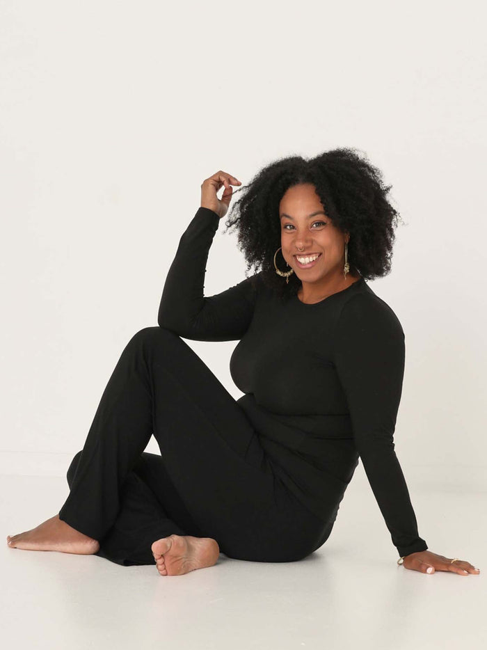 Model wearing a reversible black fitted body long sleeve t-shirt with crew and boat necklines, women's bamboo clothing