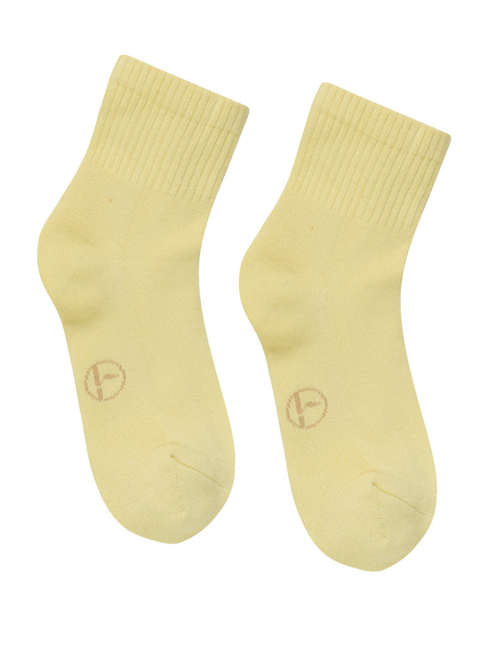 Pair of light yellow bamboo socks with a logo on a white background