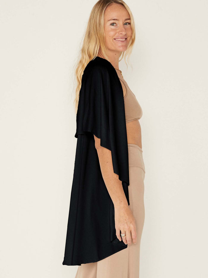 Model wearing a black convertible style goddess wrap; long cardi, vest or poncho, women's bamboo clothing