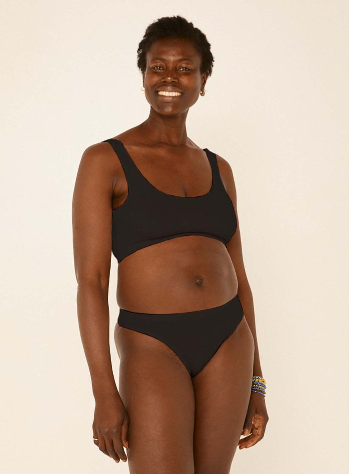 model wearing black hip g-string, mid waist, thong back, fuller coverage g-string, women's bamboo underwear