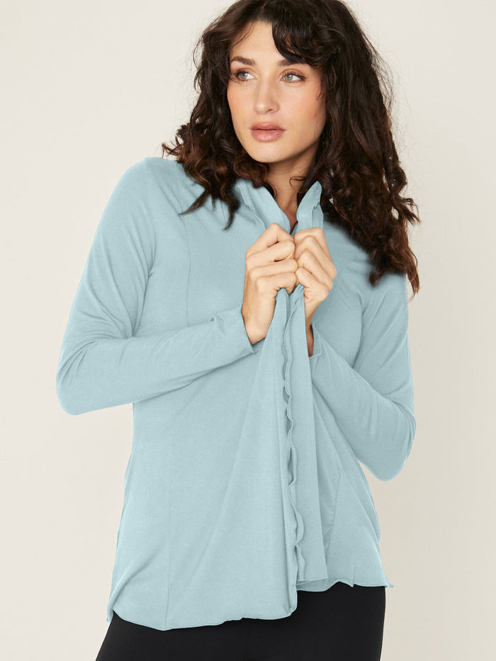 Woman wearing a bamboo light topaz blue cardigan with black wide leg palazzo pants