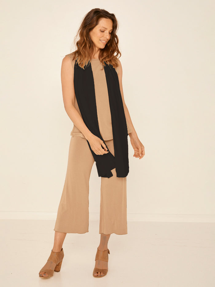 Model wearing black large scarf, convertible style worn as scarf, wrap and shawl, women's bamboo clothing accessories
