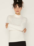 Model wearing cream high roll neck fitted skivvy, fitted long sleeves, women's bamboo clothing