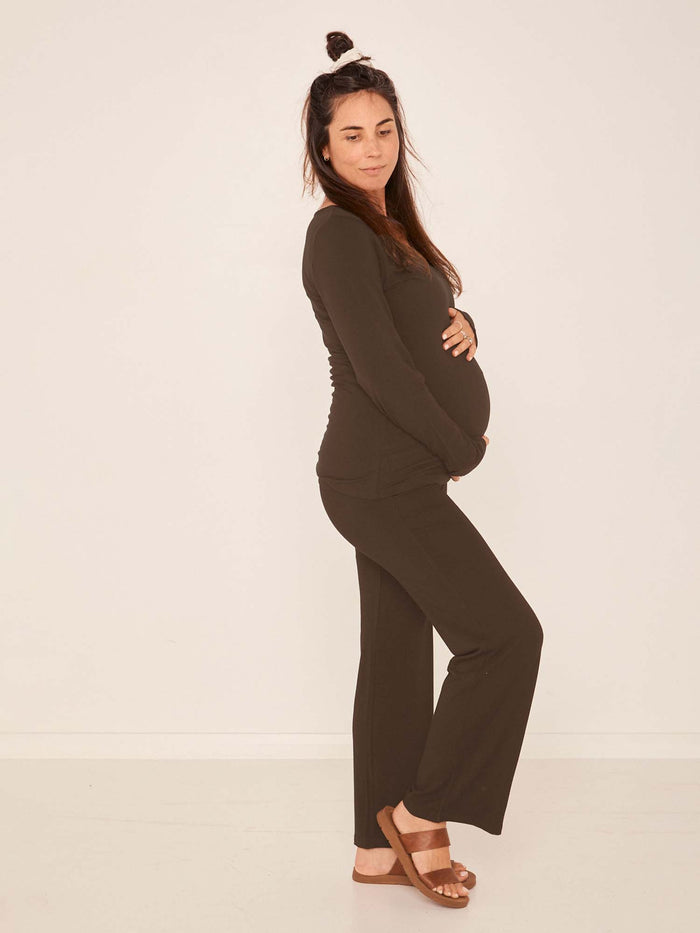 Model wearing cocoa brown full length straight leg pants, double layered adjustable/high waistband, classic cut, women's bamboo clothing