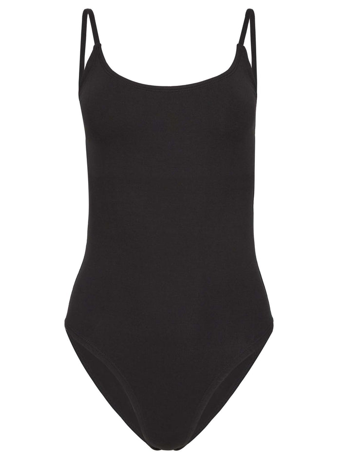 Model wearing a black strappy bodysuit with scoop neckline and adjustable straps, women's bamboo clothing