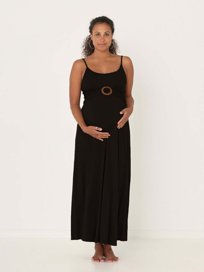 Model wearing a black swing maxi dress with a scoop neck and elasticated camisole straps, women's bamboo clothing