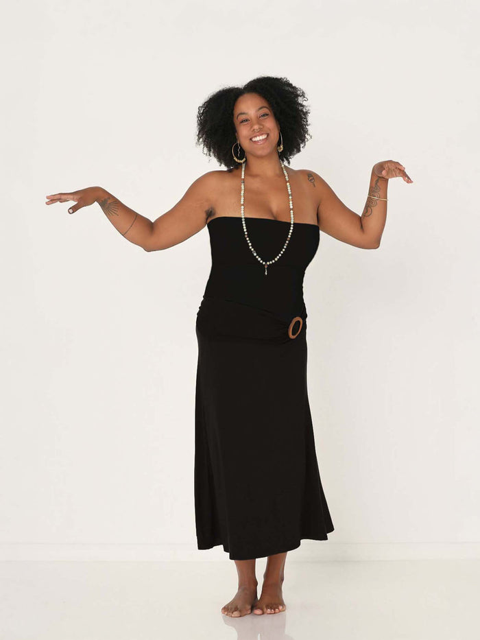 Model wearing black swing style long swishy skirt, mid - low calf length, double layered deep waistband, worn with black tube top top and belt, women's bamboo clothing