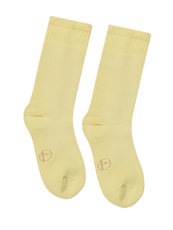 Pair of light yellow bamboo socks on a white background
