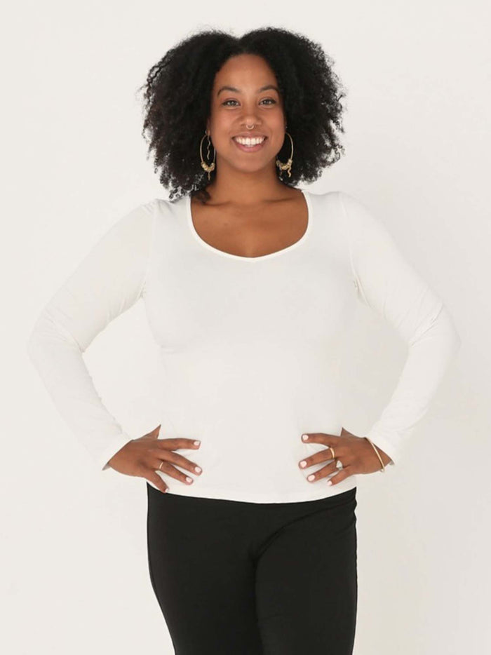 Model wearing a reversible cream fitted body, long sleeve t-shirt with v and boat necklines, women's bamboo clothing