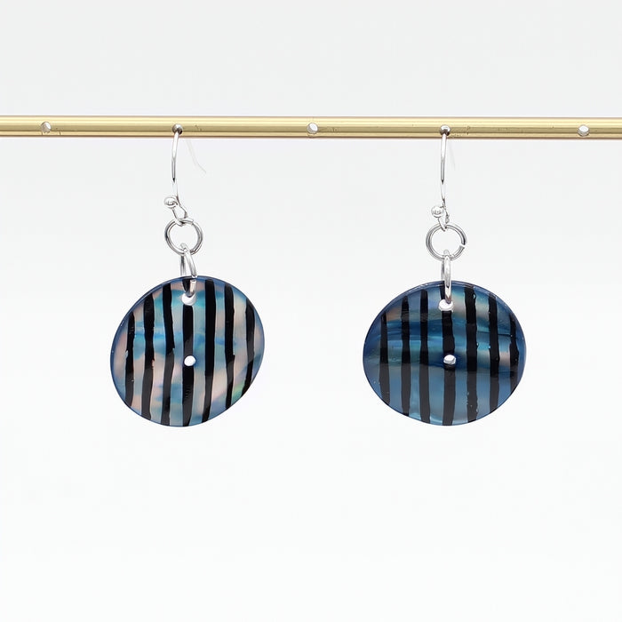 Pair of earrings with striped design on a white background