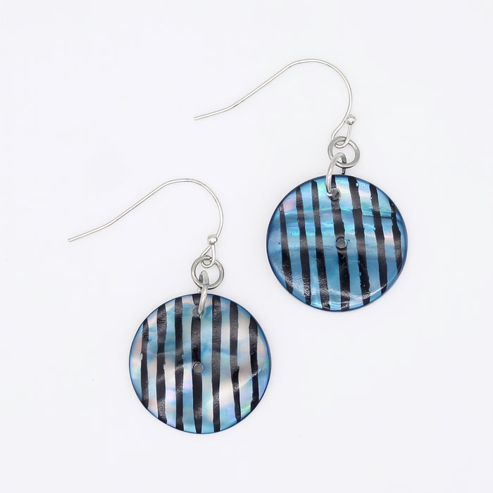 Pair of earrings with blue and black striped circular designs on a white background
