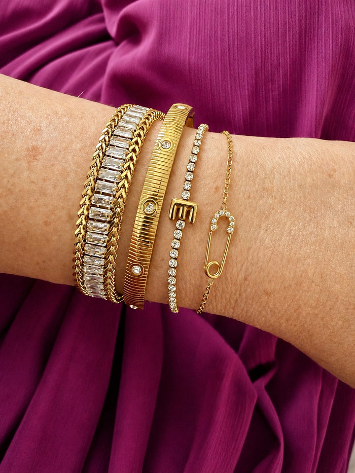 Veita Founder Erin wearing a bracelet stack featuring Delicate Salama Bracelet on the very right.