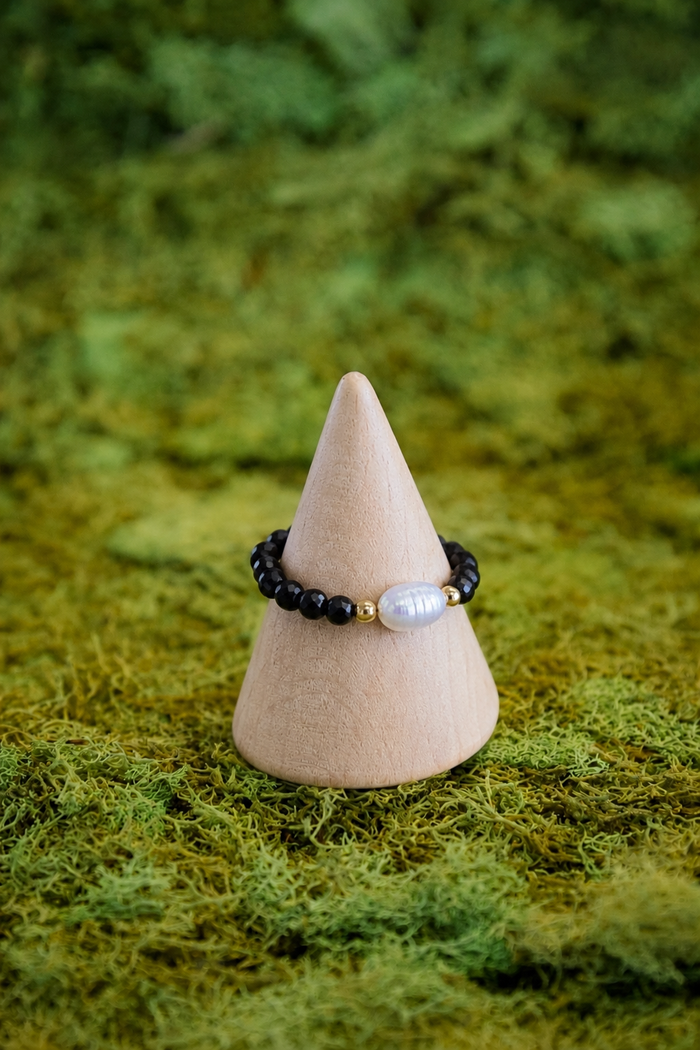 Bracelet on a wooden cone with a natural green background