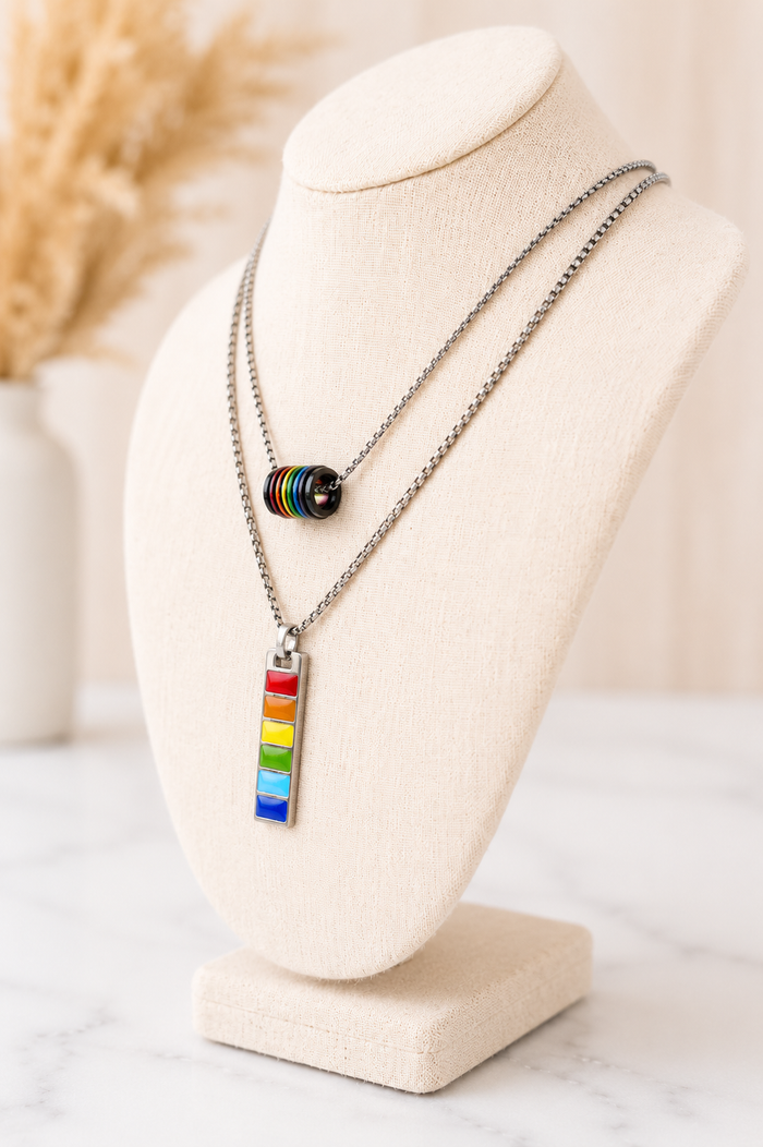 Harvey Barrel Necklace layered with a rainbow barrel pendant on a silver chain on a linen jewelry bust