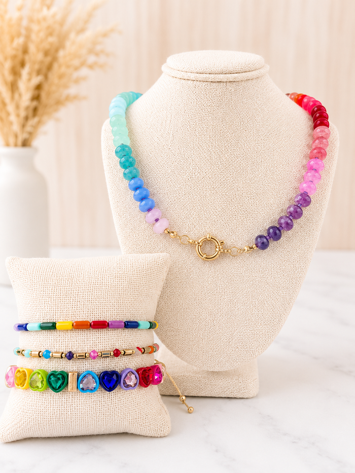 Rainbow Natural Stone Necklace with gold clasp on jewelry bust, styled with colorful beaded bracelets