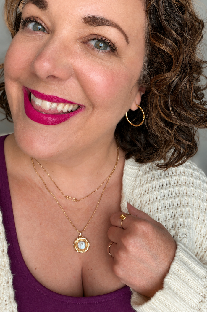 VEITA founder Erin wearing Lupita Hoops featuring lightweight twisted gold hoop earrings made from stainless steel with 18kt gold plating.
