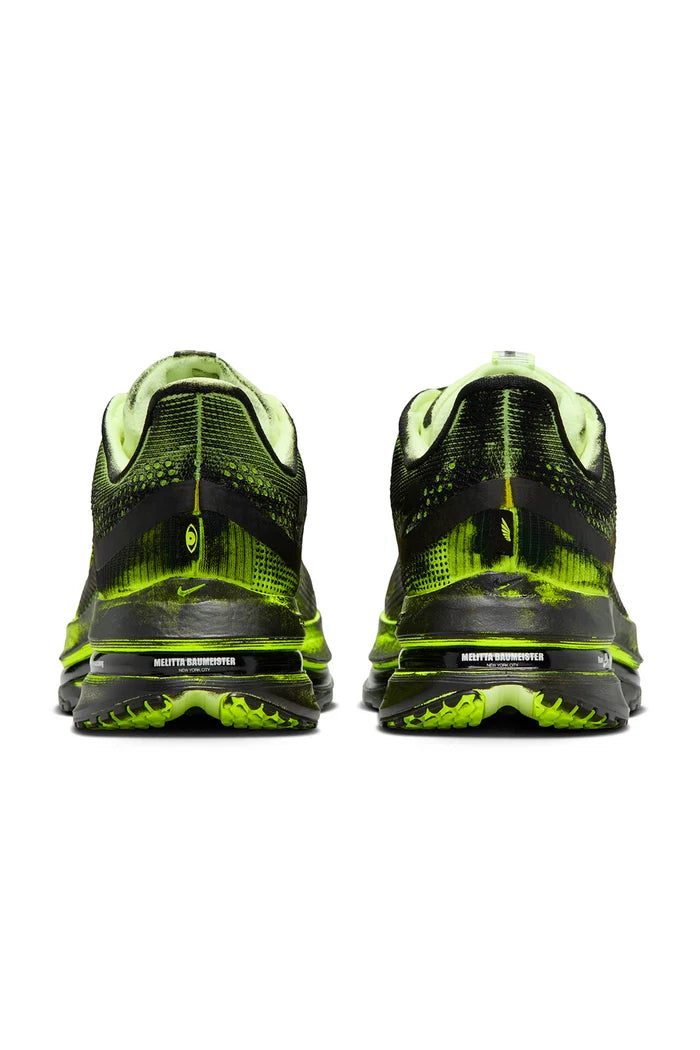 Black and green sneaker on a white background