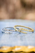 Night Coil bangle bracelets in gold and silver tones featuring coil design and 14kt gold plating on brass base