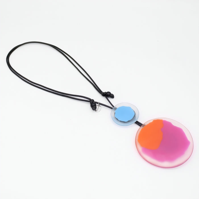 Colorful pendant necklace with a black cord on a white background