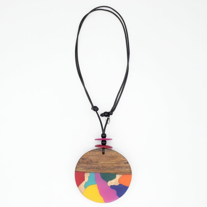 statement Necklace with a round, multicolored pendant on a white background