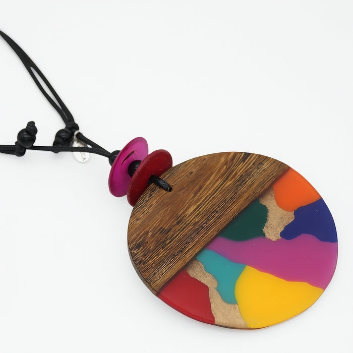 Bold Necklace with a colorful pendant featuring wooden and painted sections on a white background