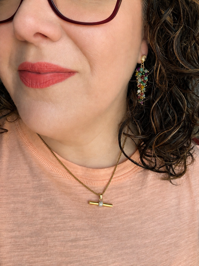Founder Erin Markland wearing Raelynn gemstone cascade earrings featuring colorful natural gemstones and 18kt gold-plated shell post earrings.