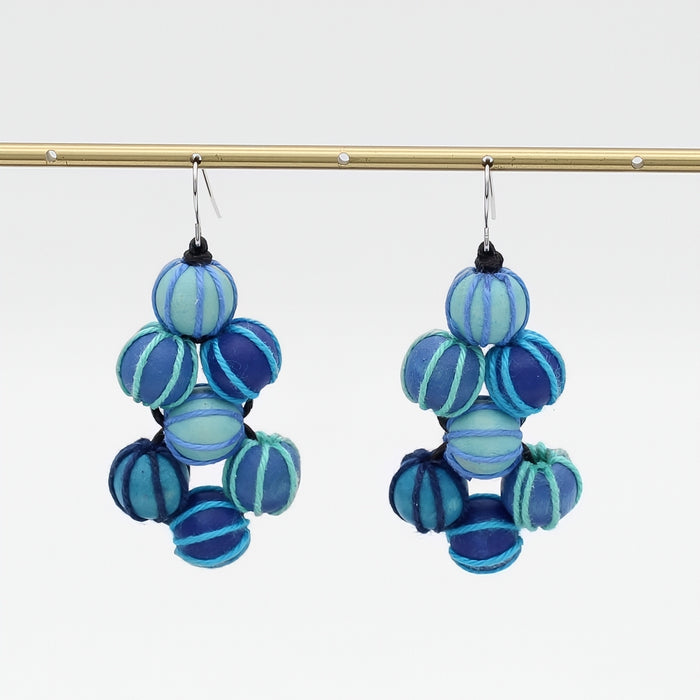 Blue and aqua beaded earrings on a white background