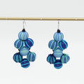 Blue and aqua beaded earrings on a white background