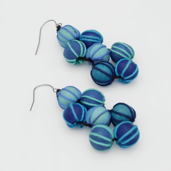 Pair of blue beaded earrings on a white background