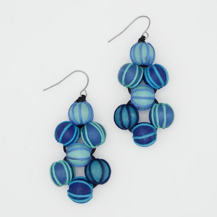 Blue and turquoise beaded earrings on a white background