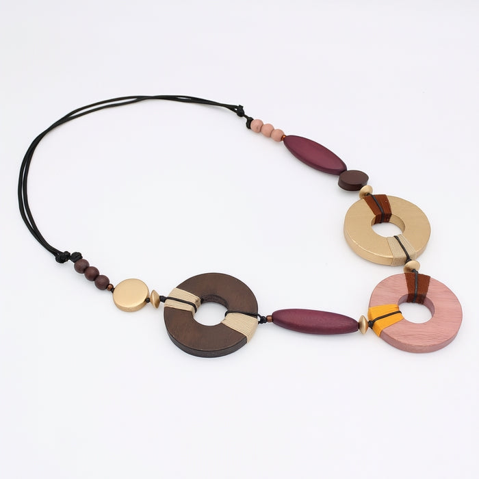 Colorful necklace with wooden and metal beads on a white background