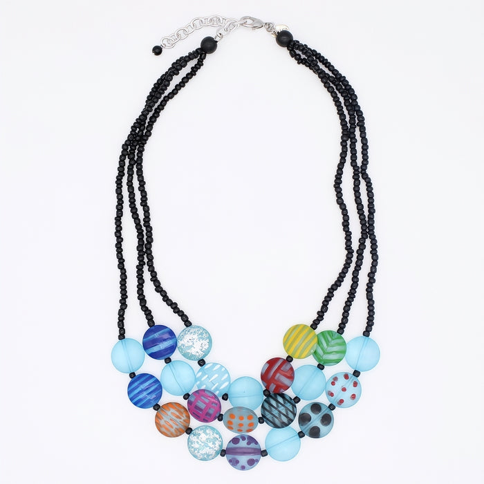 Necklace with black beads and colorful round beads on a white background