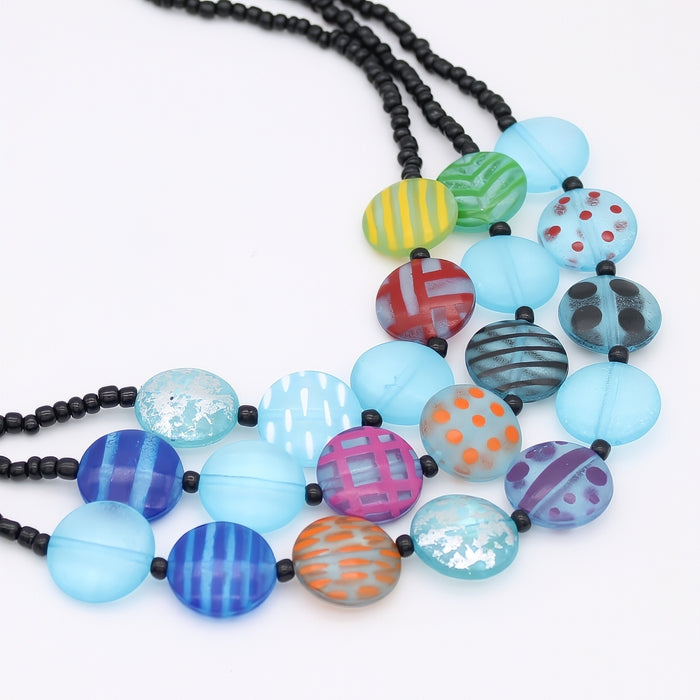 Colorful beaded necklace with black beads on a white background