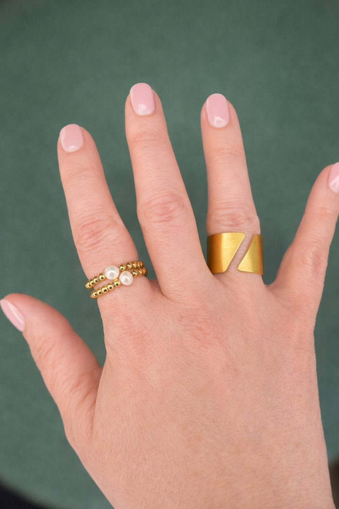 Pearl stretch rings worn on hand with Shattered Dawn Ring – Bold Gold Statement Ring on Hand