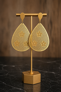 Soleri Statement Earrings featuring laser-cut teardrop earrings in stainless steel with 18kt gold plating displayed on a jewelry stand.