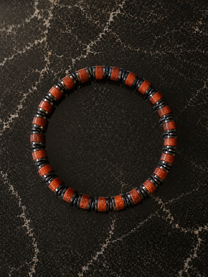 Wayfinder bracelet in Sunstone featuring red gemstone beads and hematite accents for a bold everyday look.