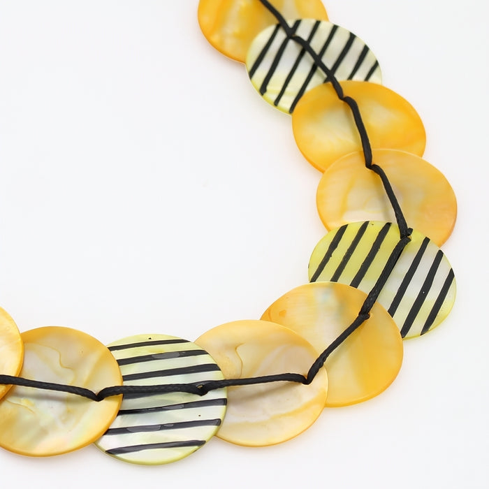 Necklace with yellow and black striped beads on a white background